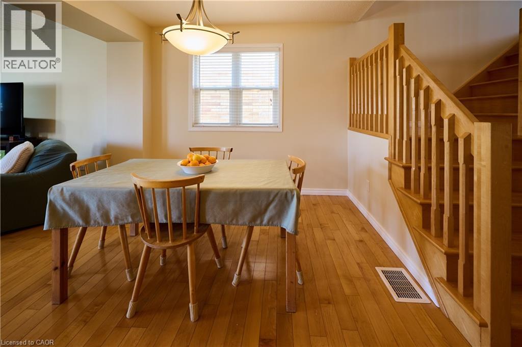 Dining area featuring hardwood / wood-style floors and baseboards - 126 Snowdrop Crescent, Kitchener, ON - Indoor Photo Showing Dining Room