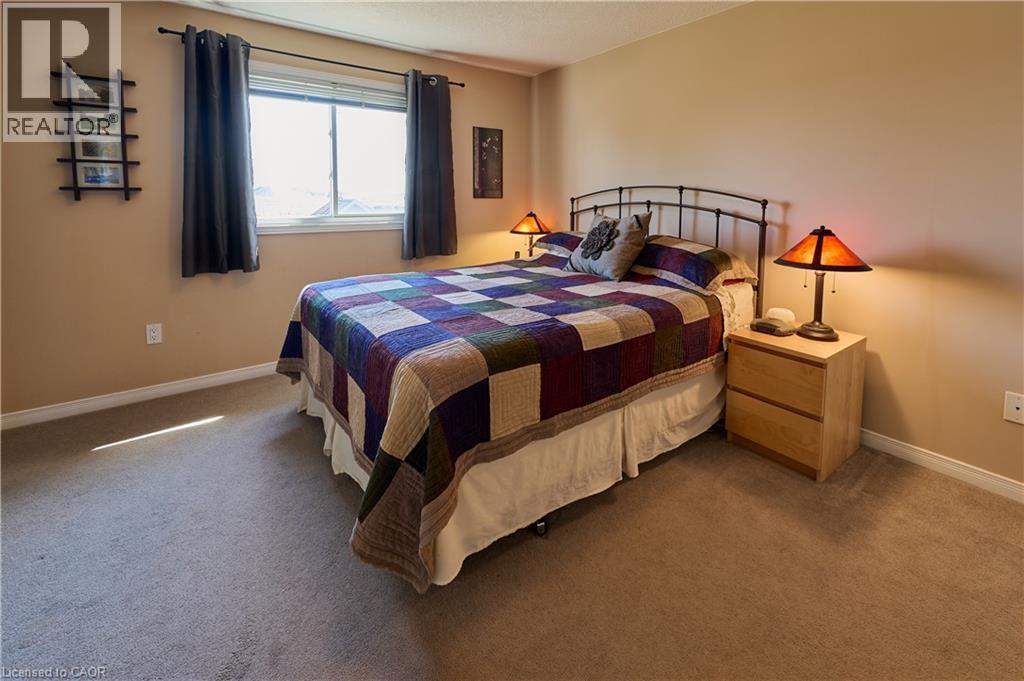 Bedroom with dark carpet and baseboards - 126 Snowdrop Crescent, Kitchener, ON - Indoor Photo Showing Bedroom