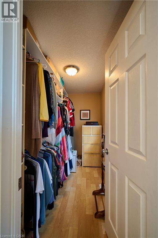 Walk in closet with light wood finished floors - 126 Snowdrop Crescent, Kitchener, ON - Indoor With Storage