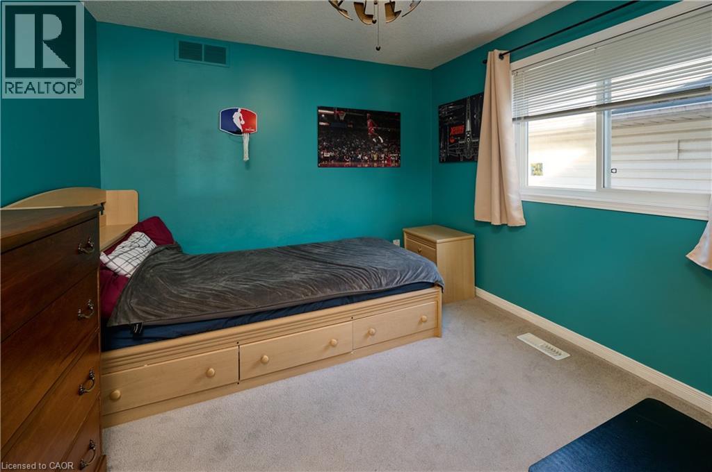 Carpeted bedroom with baseboards and a textured ceiling - 126 Snowdrop Crescent, Kitchener, ON - Indoor Photo Showing Bedroom