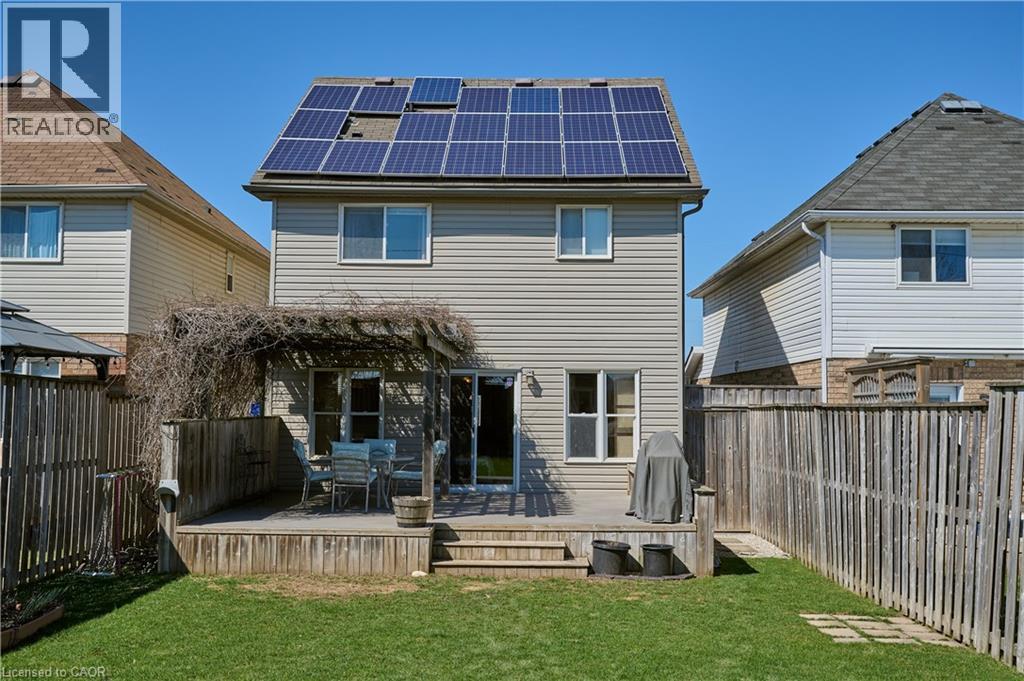 Back of house with solar panels, a fenced backyard, and a deck - 126 Snowdrop Crescent, Kitchener, ON - Outdoor With Deck Patio Veranda