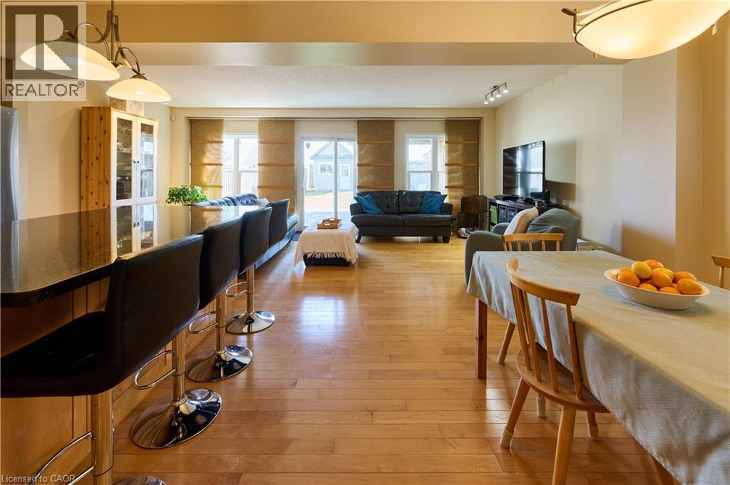 Dining area with light wood-style floors and rail lighting - 126 Snowdrop Crescent, Kitchener, ON - Indoor Photo Showing Dining Room