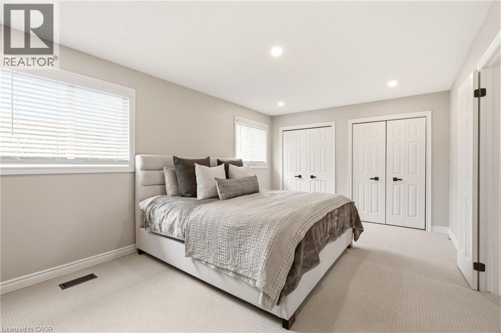 This room features light-colored walls, recessed lighting, and windows with blinds - 1 Tomahawk Drive, Grimsby, ON - Indoor Photo Showing Bedroom