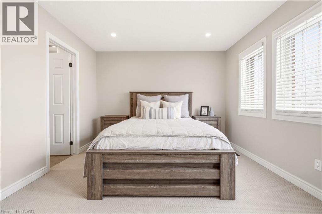 Bedroom featuring light colored walls, recessed lighting, and two windows with blinds providing natural light - 1 Tomahawk Drive, Grimsby, ON - Indoor Photo Showing Bedroom