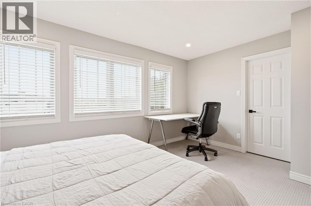 This room features carpeted flooring, light grey walls, and a recessed light fixture in the ceiling - 1 Tomahawk Drive, Grimsby, ON - Indoor Photo Showing Bedroom