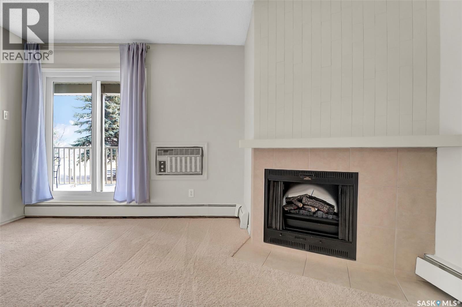 202B 1121 Mckercher Drive, Saskatoon, SK - Indoor Photo Showing Living Room With Fireplace
