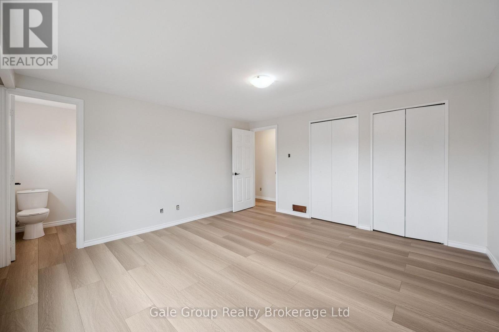 primary bedroom new flooring double closet - 165 Brookside Crescent, Kitchener, ON - Indoor Photo Showing Other Room