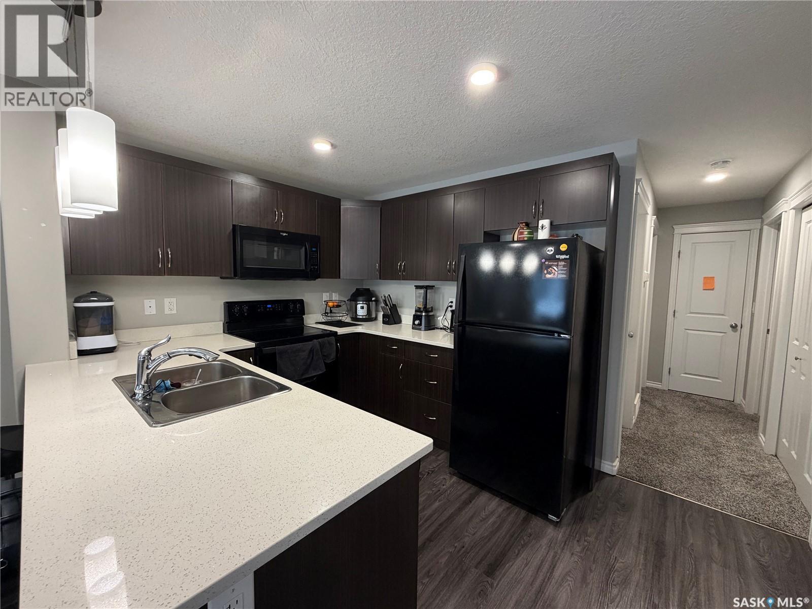 201 110 Akhtar Bend, Saskatoon, SK - Indoor Photo Showing Kitchen With Double Sink