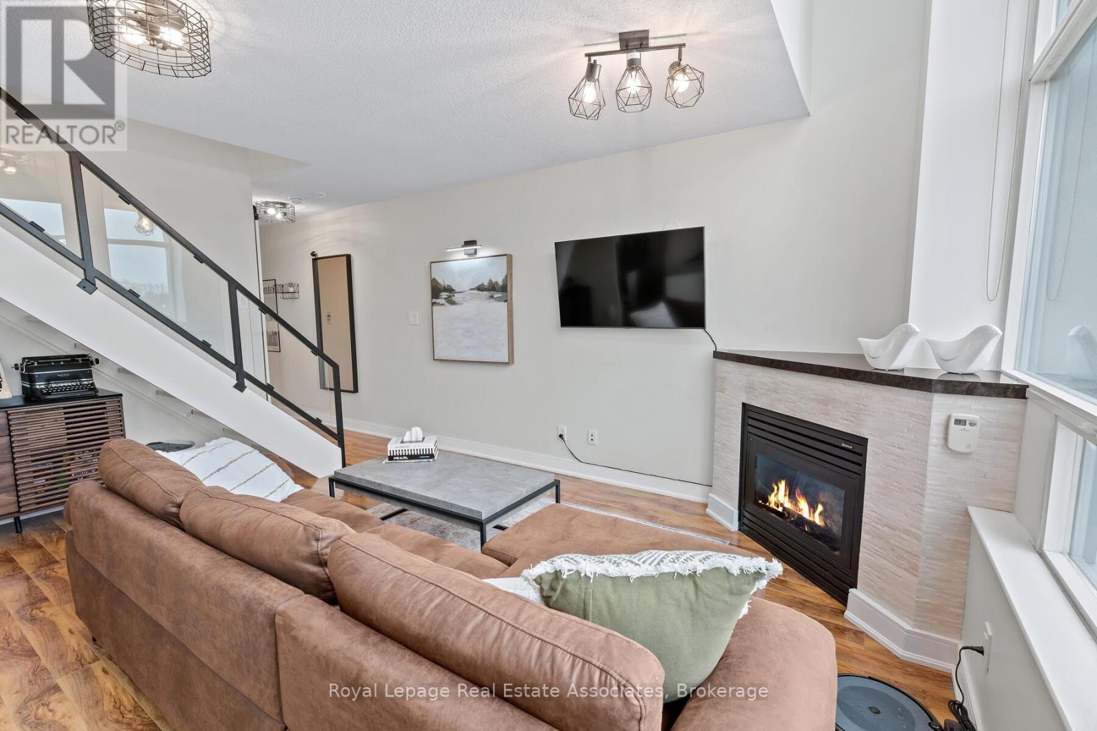 433 - 200 Manitoba Street, Toronto, ON - Indoor Photo Showing Living Room With Fireplace