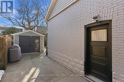 Side entrance to basement and single garage -