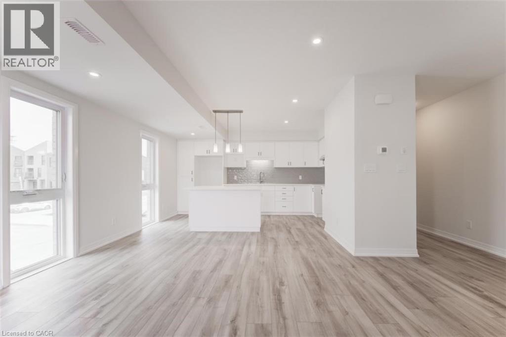 Open concept living space featuring light-toned flooring, recessed lighting, and large windows providing natural light - 686 Benninger Drive, Kitchener, ON - Indoor