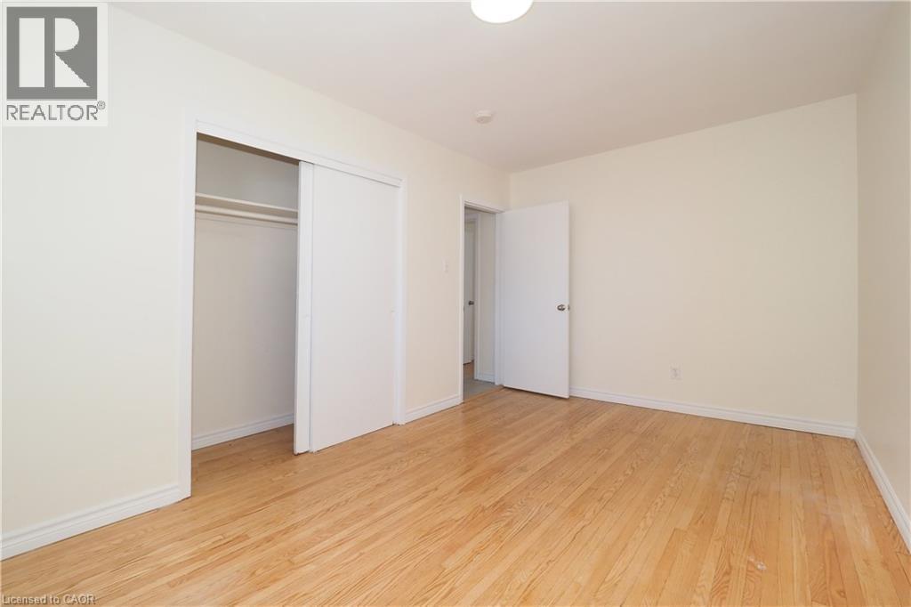 This room features hardwood floors and light-colored walls, creating a bright and airy atmosphere - 24 Austin Drive, Waterloo, ON - Indoor Photo Showing Other Room
