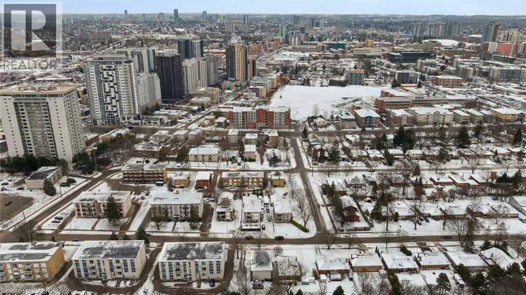Aerial view of the surrounding urban landscape, showcasing a mix of residential properties with snow-covered rooftops and streets - 24 Austin Drive, Waterloo, ON - Outdoor With View