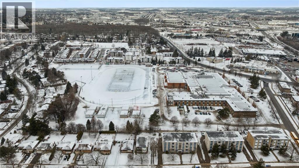 Aerial view of the neighborhood showcasing surrounding residential properties, commercial buildings, and a large recreational field - 24 Austin Drive, Waterloo, ON - Outdoor With View