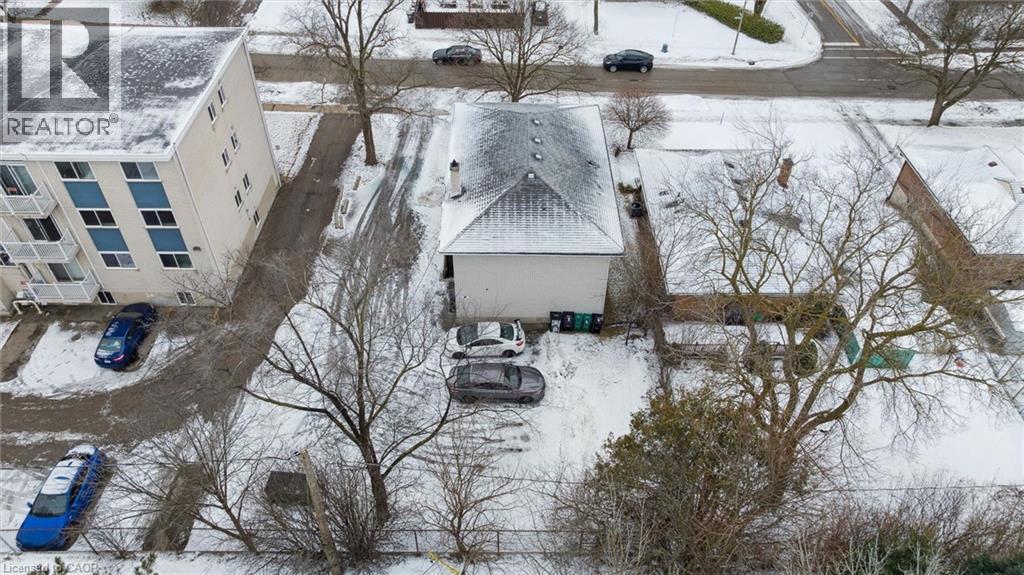 The property features a peaked roof and an expansive driveway with space for parking - 24 Austin Drive, Waterloo, ON - Outdoor