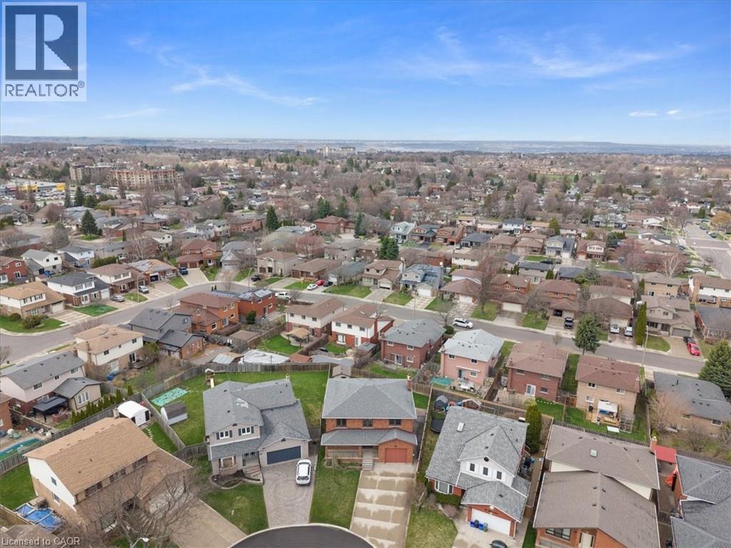 Aerial view showcasing the residential neighborhood with a variety of homes, each with individual driveways and green spaces - 18 Marcel Place, Hamilton, ON - Outdoor With View