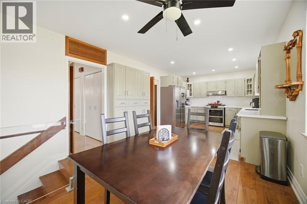 This space features hardwood flooring, a ceiling fan, and recessed lighting - 38 Leclaire Street, Hamilton, ON - Indoor Photo Showing Other Room
