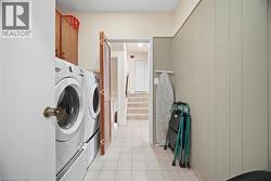 The property features a dedicated laundry area with white appliances and a tiled floor -