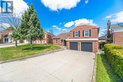 The property features a brick exterior, a two-car garage, and a concrete driveway -