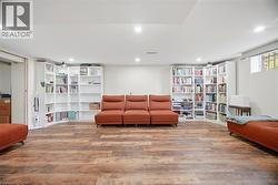 This expansive room features plank flooring and recessed lighting -