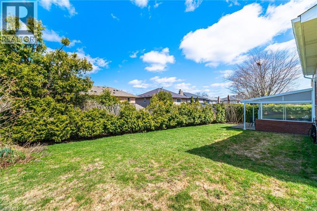 The property features a spacious yard with a well-maintained lawn - 38 Leclaire Street, Hamilton, ON - Outdoor