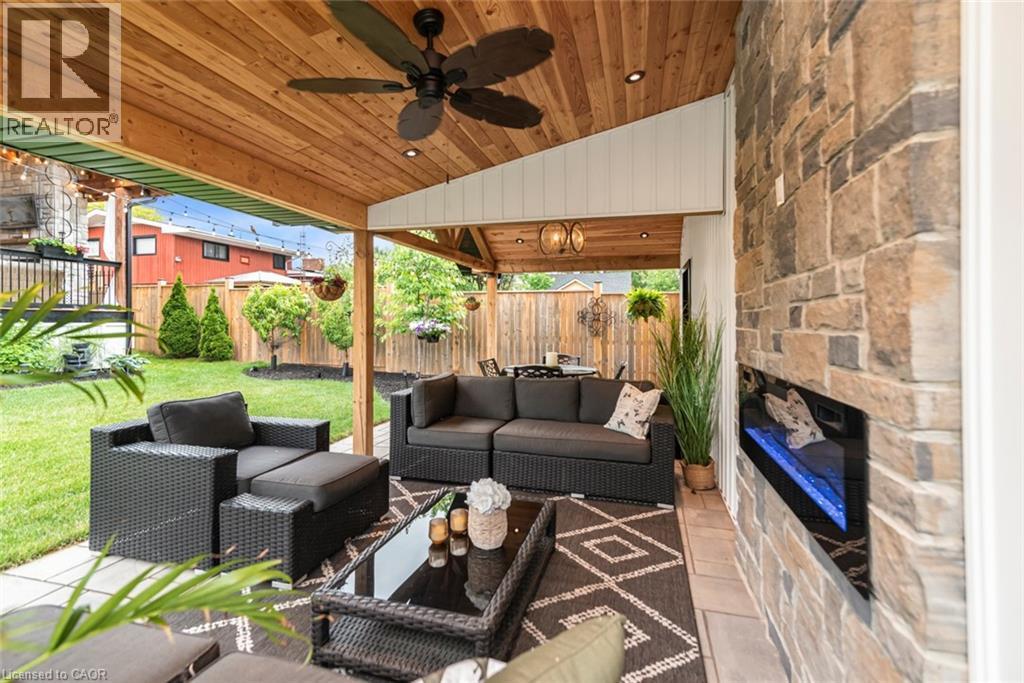 Covered patio featuring a wood-plank ceiling, recessed lighting, and a ceiling fan - 253 Central Avenue, Grimsby, ON