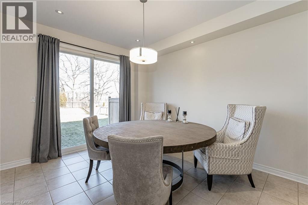 Dining area featuring light-colored tile flooring, a contemporary ceiling light fixture, and recessed lighting - 2453 Village Common, Oakville, ON - Indoor Photo Showing Dining Room