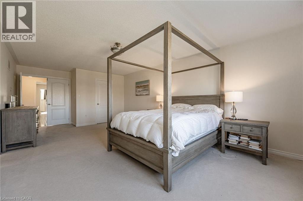 This room features light-colored carpeting, painted walls, and white trim - 2453 Village Common, Oakville, ON - Indoor Photo Showing Bedroom