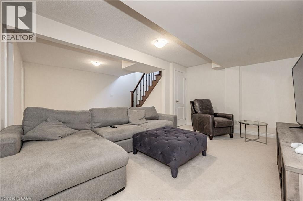 Spacious recreation room featuring light-colored carpeting, white walls, and recessed lighting - 2453 Village Common, Oakville, ON - Indoor