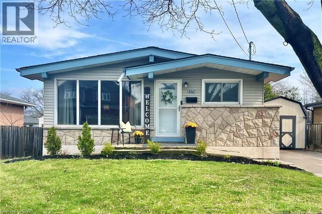 A charming exterior featuring light gray siding, a prominent stone facade, and a well-maintained lawn - 241 Thorner Drive, Hamilton, ON - Outdoor
