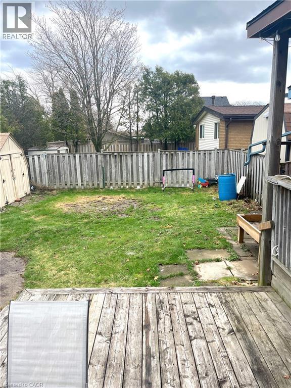 The property features a wood deck overlooking a lawn area with a wooden fence - 241 Thorner Drive, Hamilton, ON - Outdoor With Deck Patio Veranda