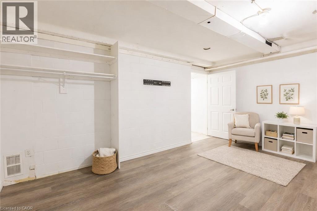 This versatile space features light-toned flooring, white walls, and an open doorway leading to another area - 121 University Avenue E Unit# 102, Waterloo, ON - Indoor