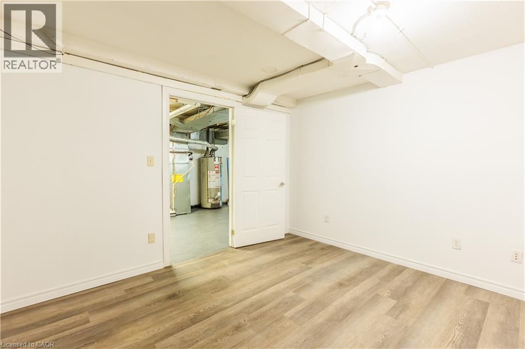 Room with light wood-style flooring and white walls - 121 University Avenue E Unit# 102, Waterloo, ON - Indoor Photo Showing Other Room
