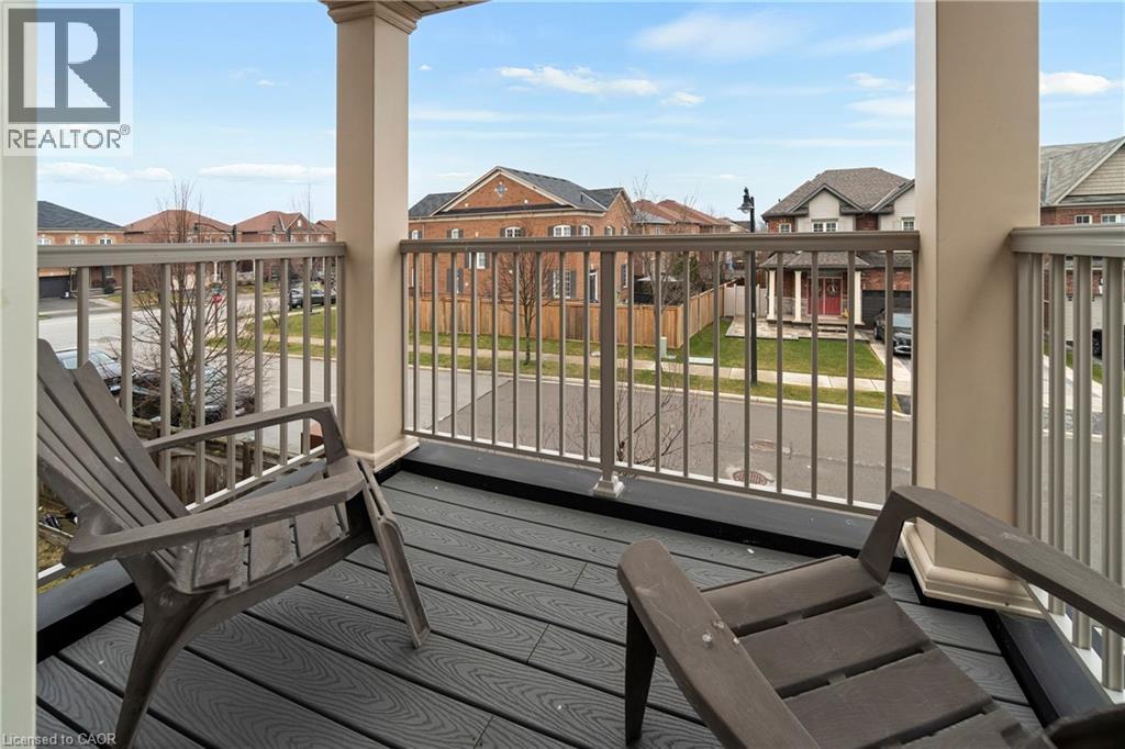 The property features a balcony with composite decking, providing an elevated view of the neighborhood - 4 Macbean Crescent, Waterdown, ON - Outdoor With Balcony With Exterior