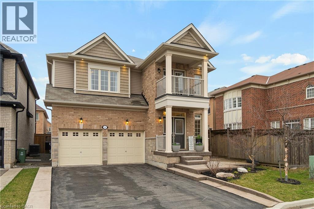 The property features a brick exterior with complementary siding, a two-car garage, and a welcoming front entrance with a covered porch and an upper balcony - 4 Macbean Crescent, Waterdown, ON - Outdoor With Balcony With Facade