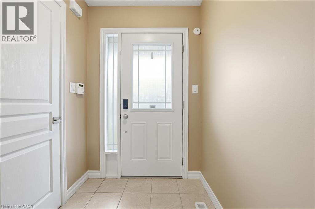 Entryway featuring tile patterned flooring and baseboards - 91 Chamomile Drive, Hamilton, ON - Indoor Photo Showing Other Room