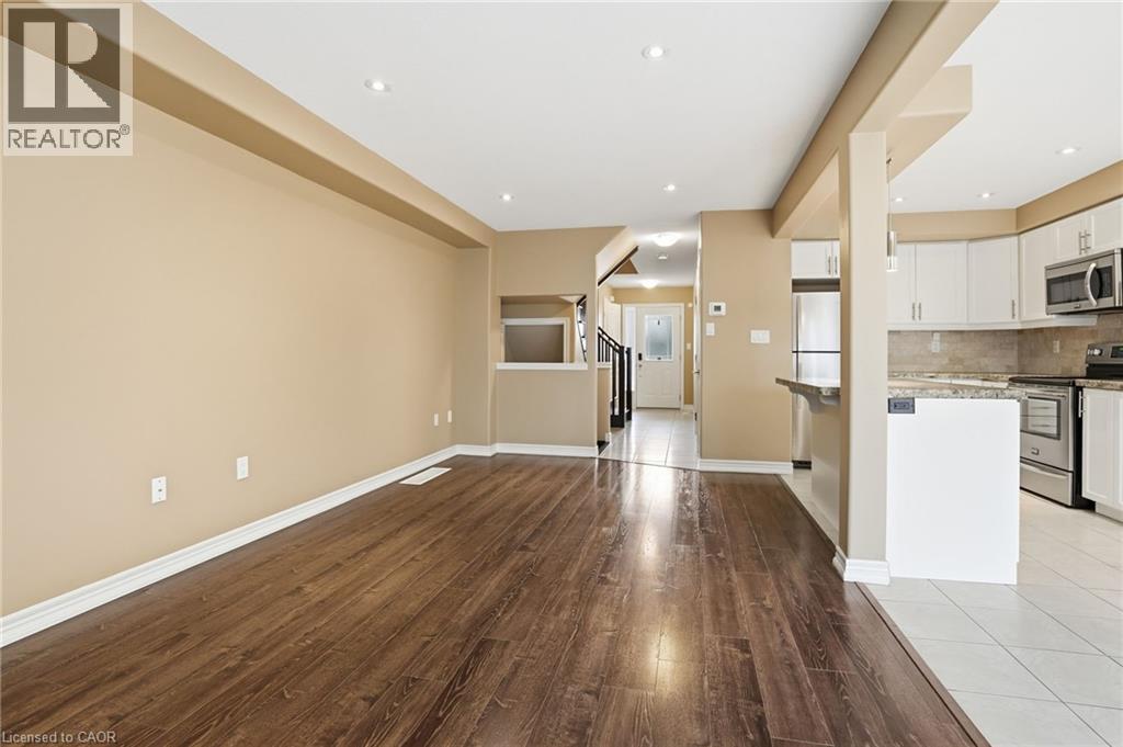 Unfurnished living room with light wood-style flooring and recessed lighting - 91 Chamomile Drive, Hamilton, ON - Indoor Photo Showing Kitchen