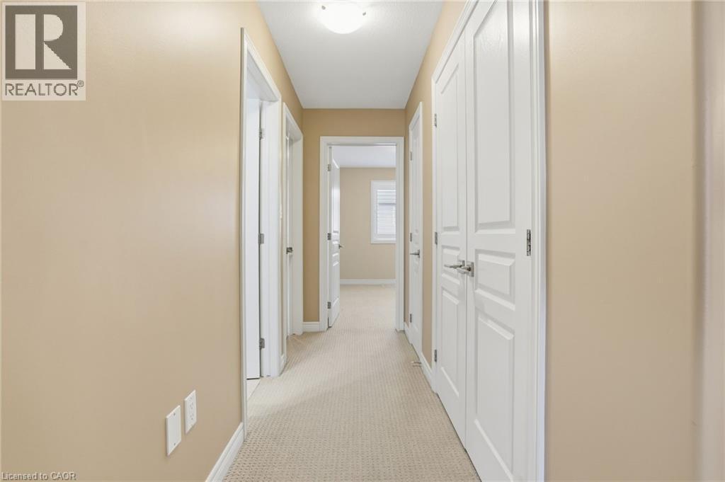 Hallway featuring light carpet and baseboards - 91 Chamomile Drive, Hamilton, ON - Indoor Photo Showing Other Room