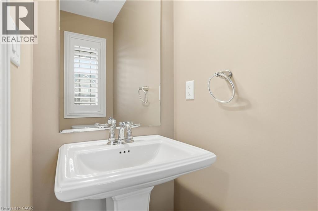 Main Floor powder room with pedestal sink - 91 Chamomile Drive, Hamilton, ON - Indoor Photo Showing Bathroom