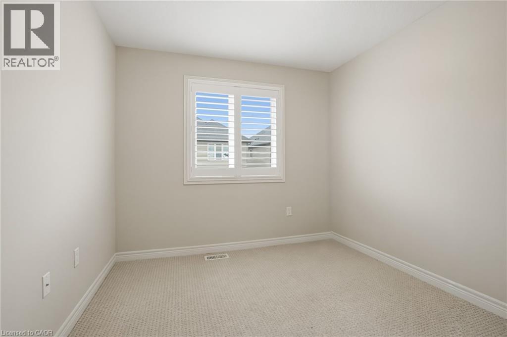 Unfurnished room featuring light colored carpet and baseboards - 91 Chamomile Drive, Hamilton, ON - Indoor Photo Showing Other Room