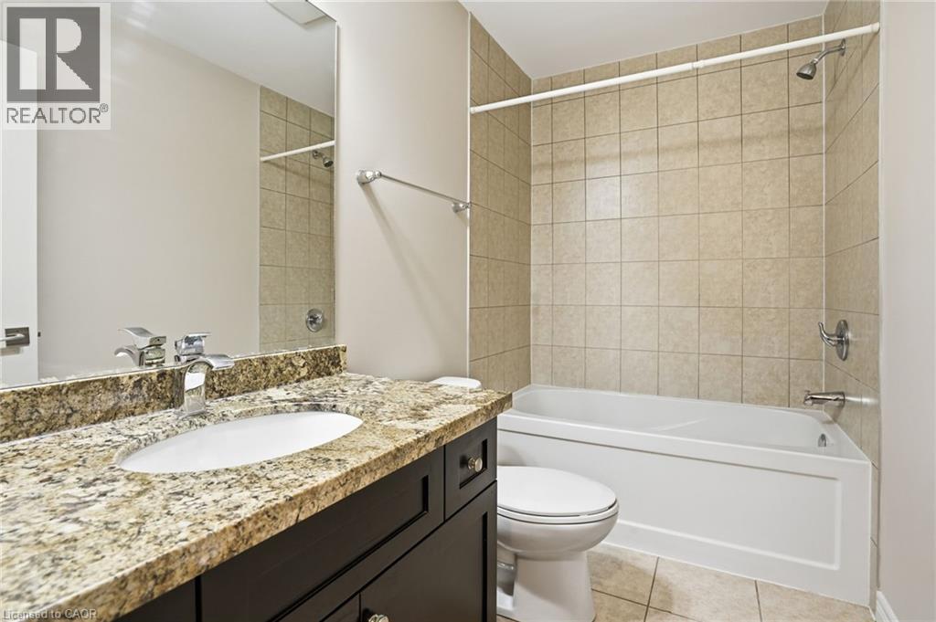Full bathroom featuring vanity, light tile patterned floors, and shower combination - 91 Chamomile Drive, Hamilton, ON - Indoor Photo Showing Bathroom