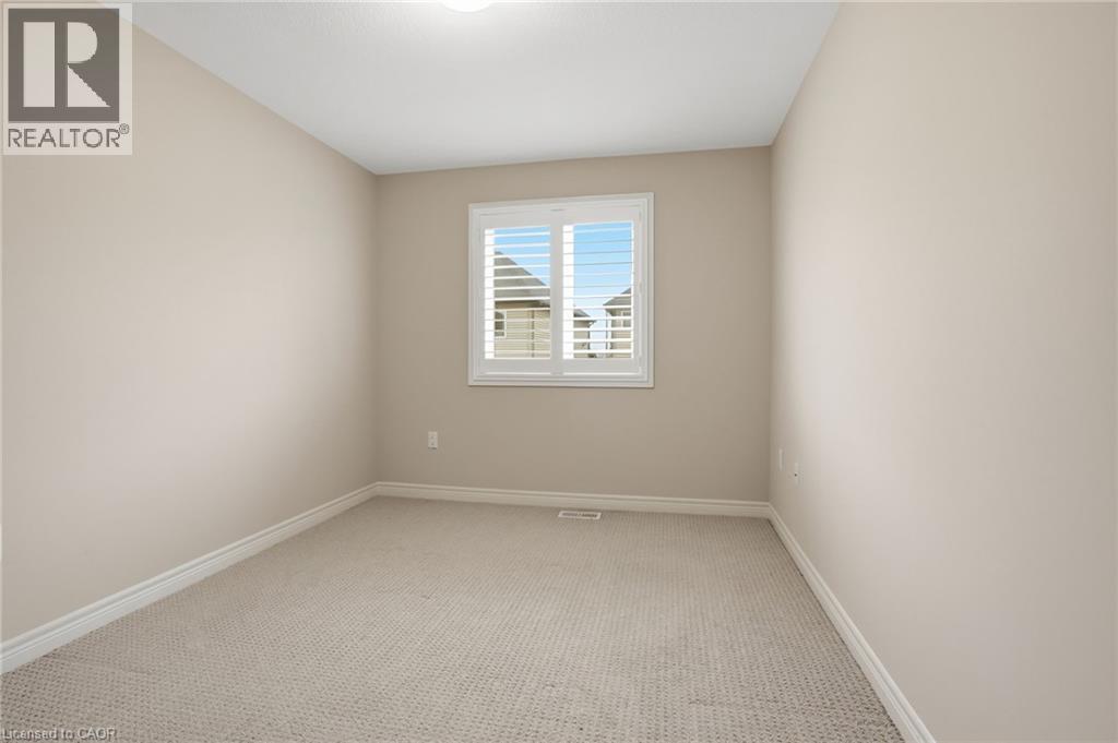 Unfurnished room featuring light colored carpet and baseboards - 91 Chamomile Drive, Hamilton, ON - Indoor Photo Showing Other Room