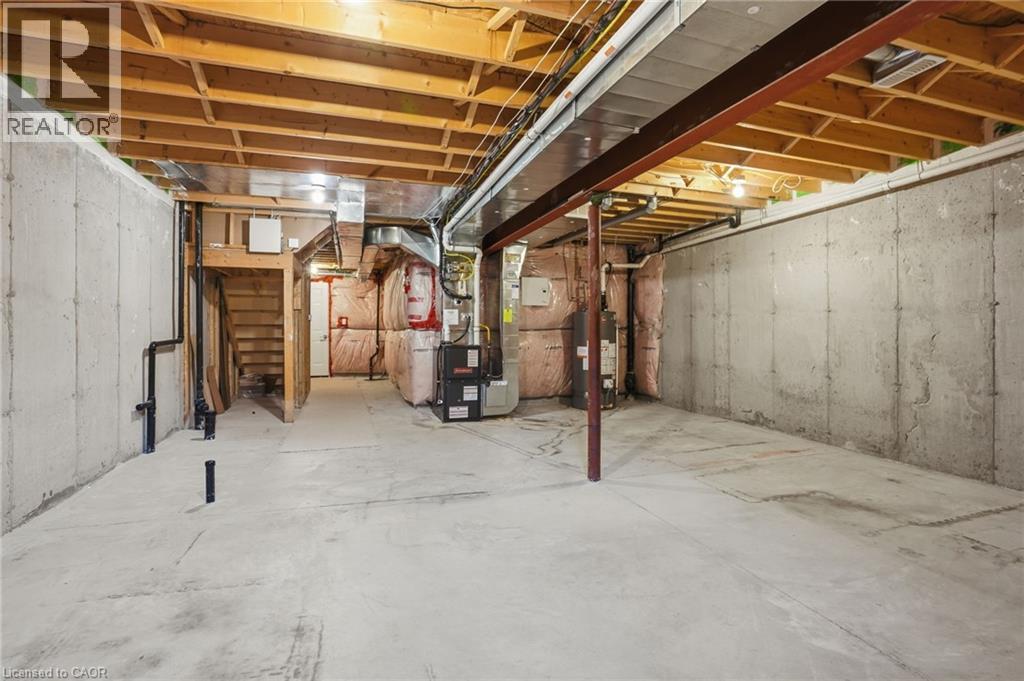 Unfinished below grade area featuring gas water heater and heating unit - 91 Chamomile Drive, Hamilton, ON - Indoor Photo Showing Basement