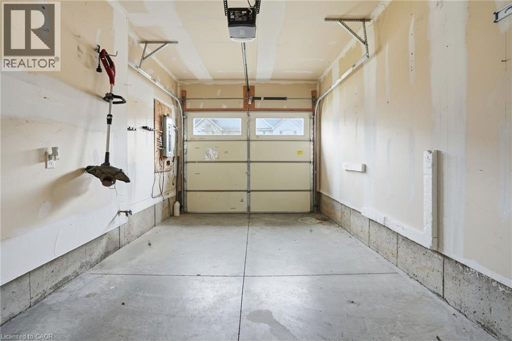 Garage featuring a garage door opener - 91 Chamomile Drive, Hamilton, ON - Indoor Photo Showing Garage
