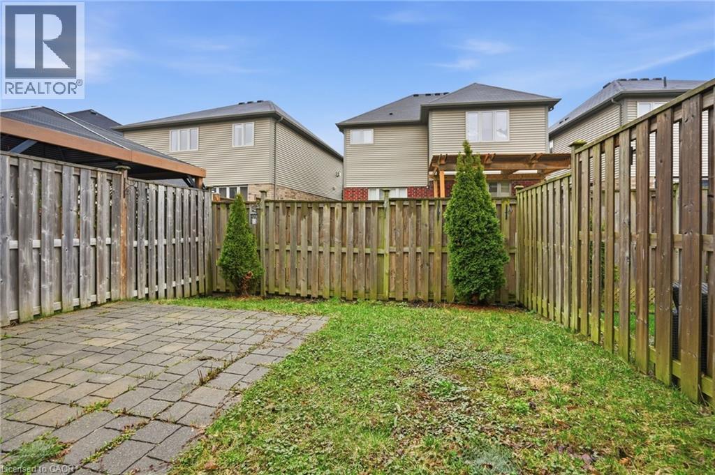 Fenced backyard featuring a patio area and a residential view - 91 Chamomile Drive, Hamilton, ON - Outdoor