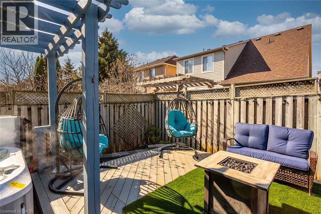 Deck with a fire pit, a pergola, and a fenced backyard - 599 Caverhill Crescent, Milton, ON - Outdoor With Deck Patio Veranda