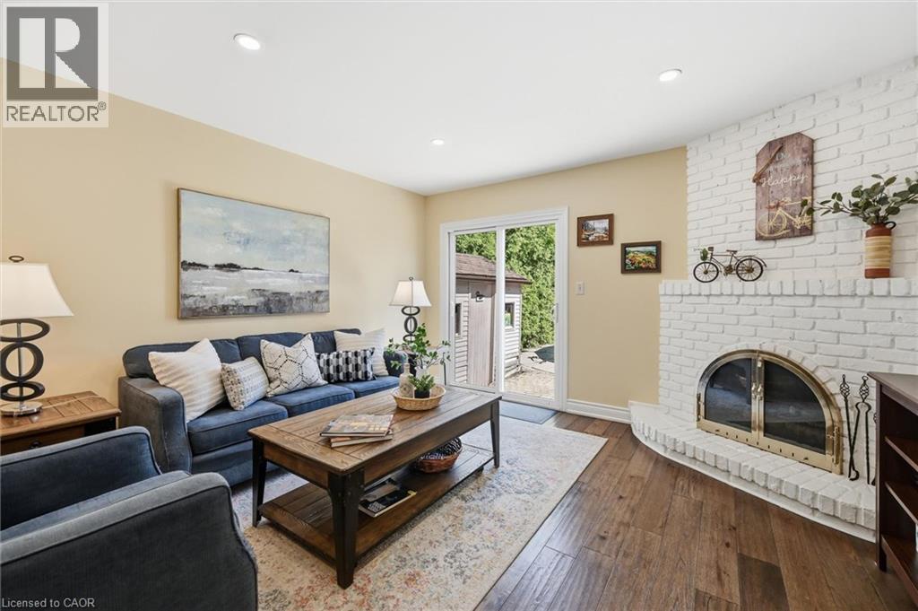 Sliding Doors to Back Yard - 2648 Cavendish Drive, Burlington, ON - Indoor Photo Showing Living Room With Fireplace