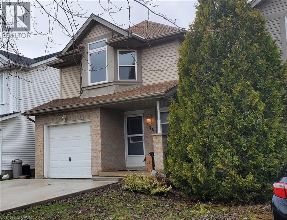 The property features a brick and siding exterior, a white garage door, and a front entrance with a covered porch - 725 Paris Boulevard, Waterloo, ON - Outdoor