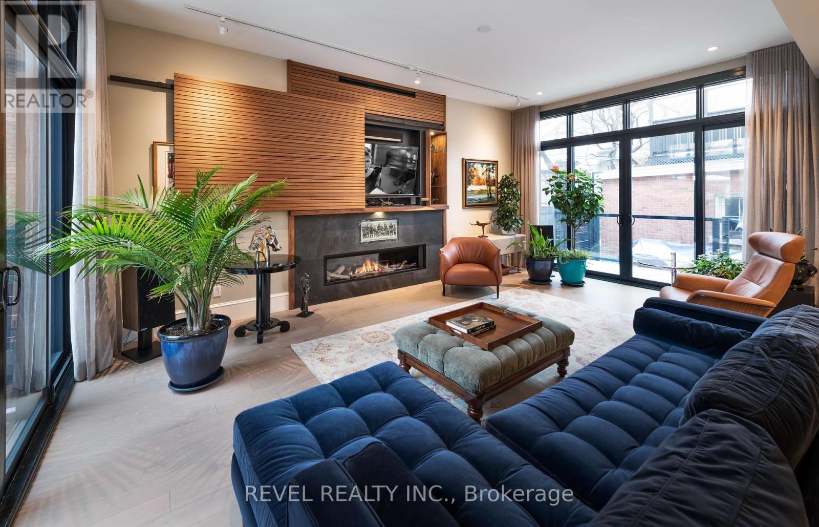 Main Level Living Room TV Panel Open - 90 Powell Avenue, Ottawa, ON - Indoor Photo Showing Living Room With Fireplace