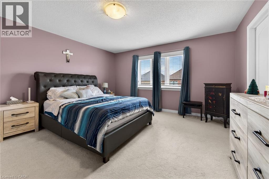 Bedroom with a light-colored carpeted floor and painted walls - 44 Matteo Trail, Hamilton, ON - Indoor Photo Showing Bedroom